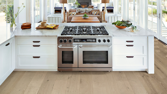 wide wood planks in a bright and airy open concept kitchen and living room